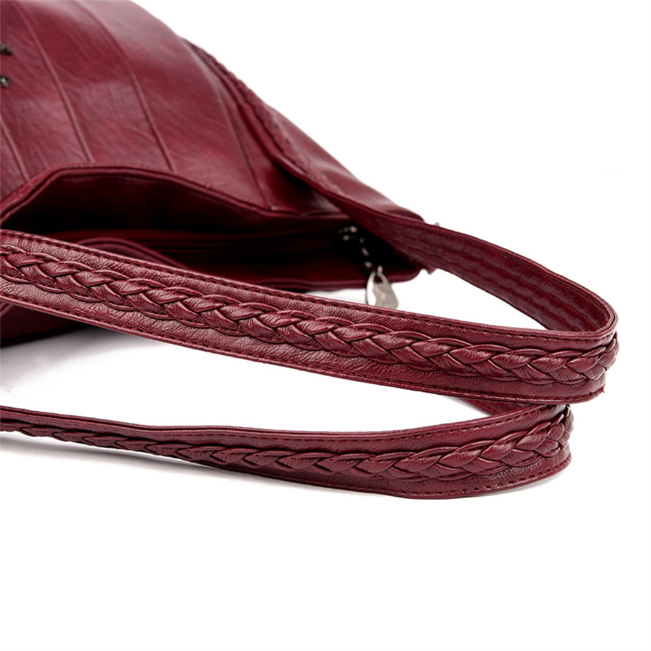 sac a main bordeaux cuir detail des anses tresse