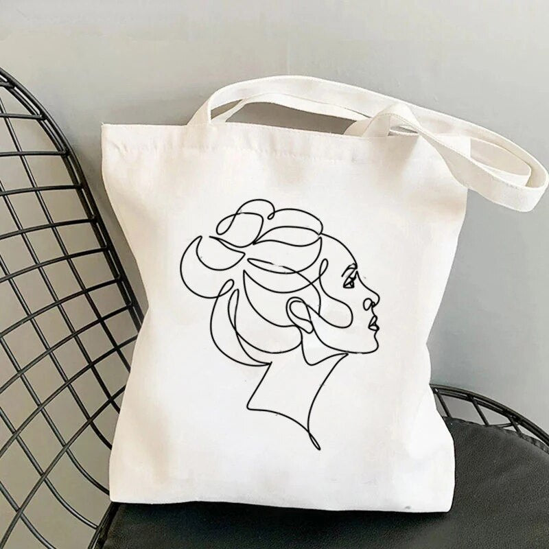 tote bag design avec ligne qui represente une femme