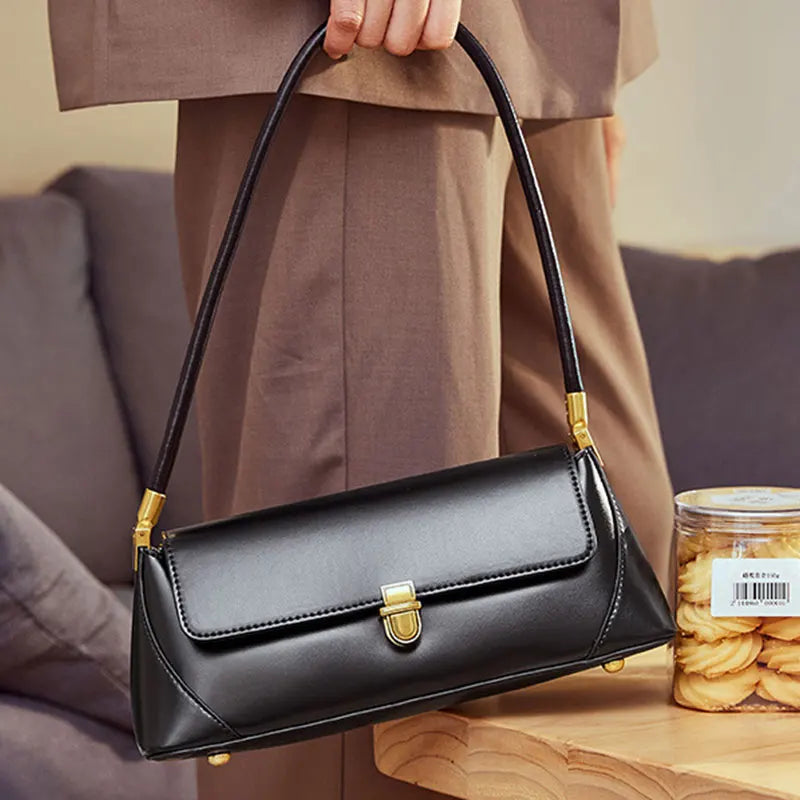 sac à main noir et doré porté épaule femme